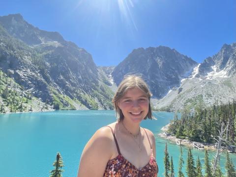 Grace in front of light blue and mountains